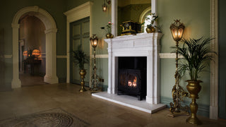 Image of a white marble fireplace in a luxurious green hallway