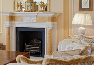 editorial photography of a luxurious stone fireplace in white and yellow marble